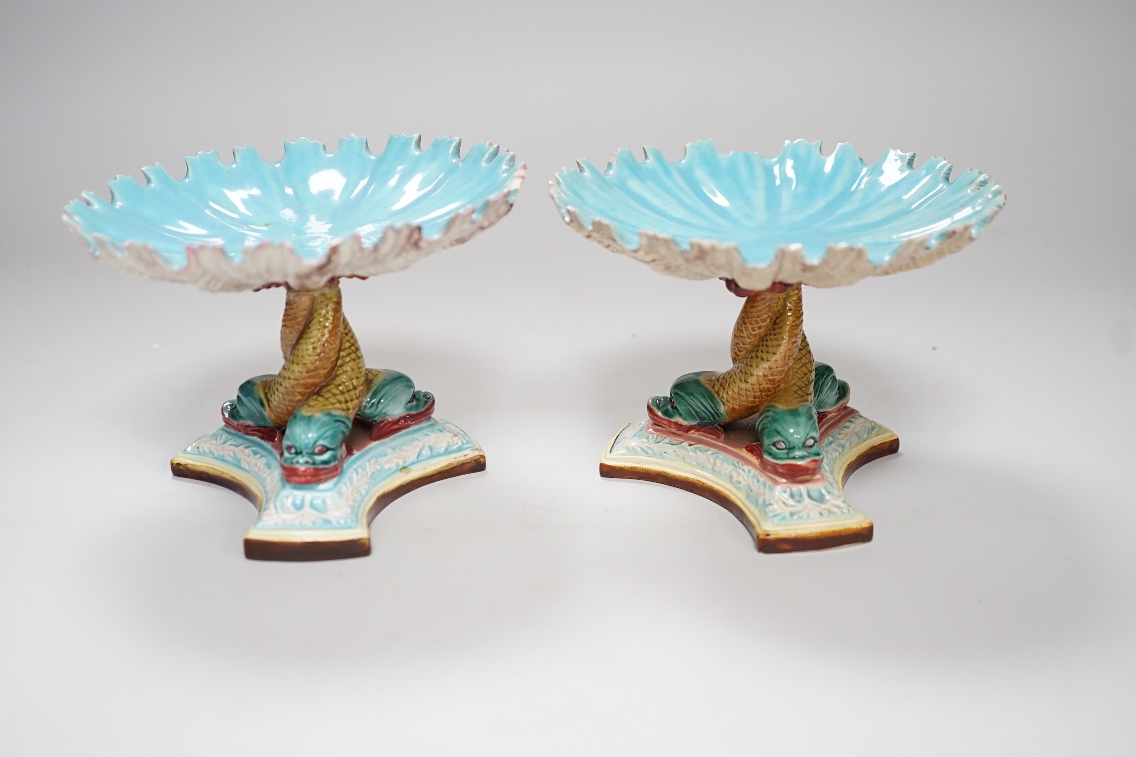 A pair of late 19th century Royal Worcester majolica dolphin comports, 10cm tall